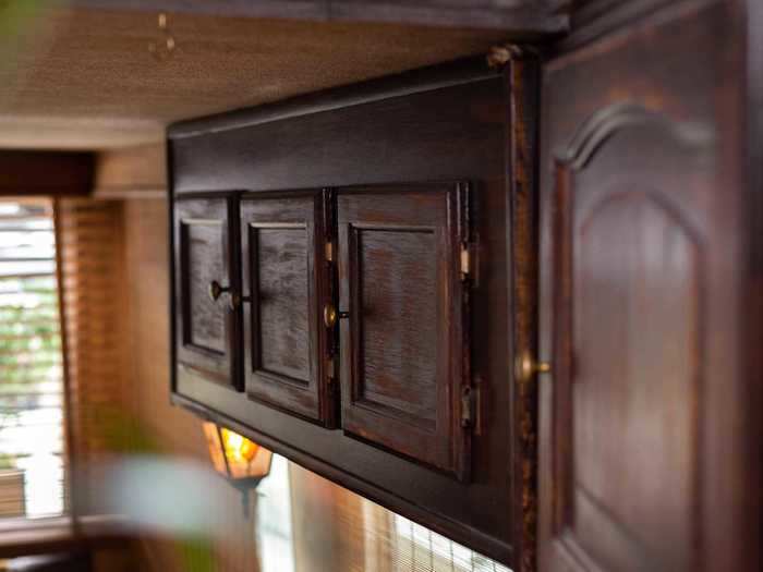 Above the desk, there are wood-stained cabinets for additional storage.