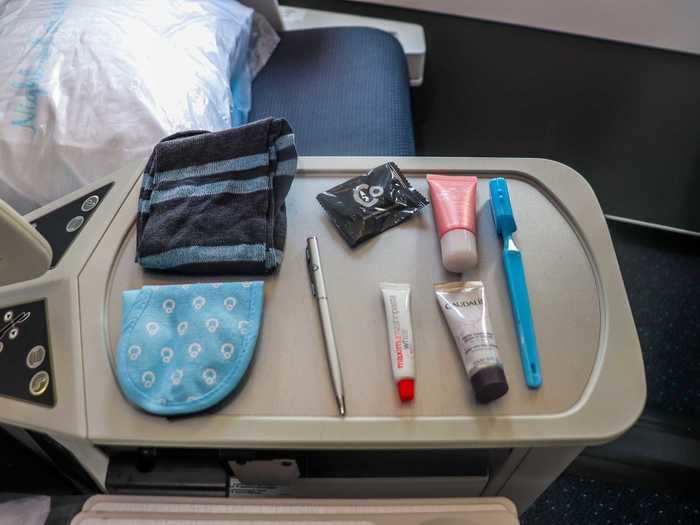 Inside are the essentials such as an eye mask, socks, and lotions.