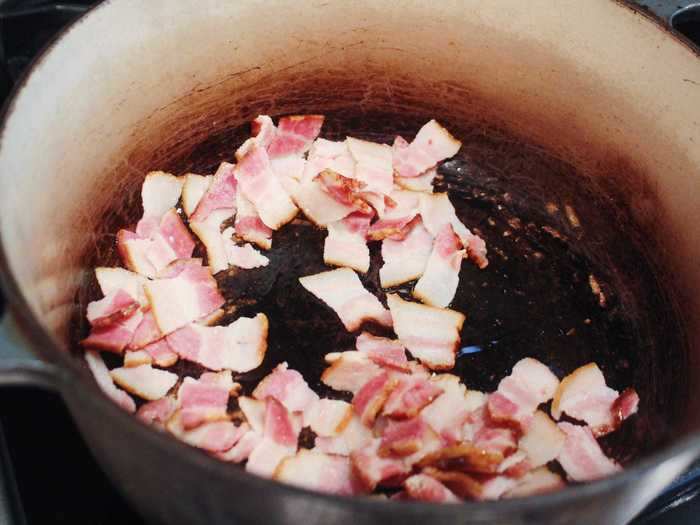 After straining the bacon with a slotted spoon and placing it on a paper towel to dry, I lightly browned it in my well-loved Le Creuset Dutch oven.