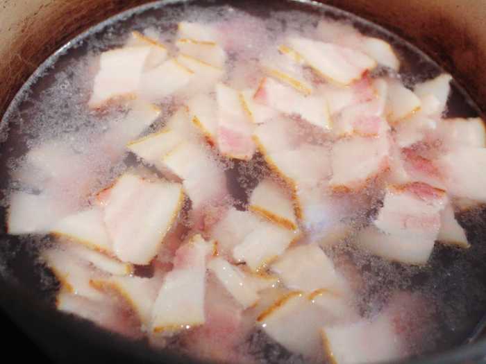 Rather than frying the bacon right away, the recipe requires placing it in simmering water for 10 minutes.