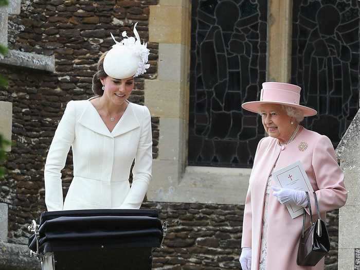 Queen Elizabeth wore a pale pink coat and hat over a white dress.