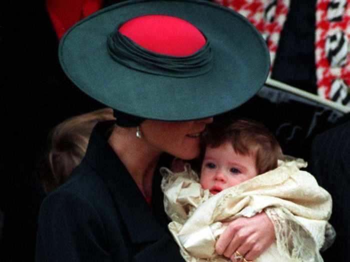 The Duchess of York wore a dark green outfit and a wide-brimmed hat with a bright red center for Princess Eugenie