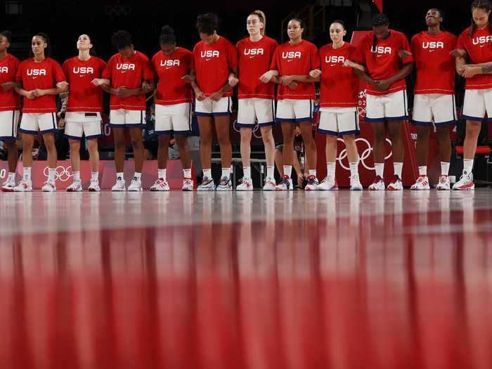 Team USA stands with arms interlocked as the national anthem plays ahead of their semifinal game against Serbia.