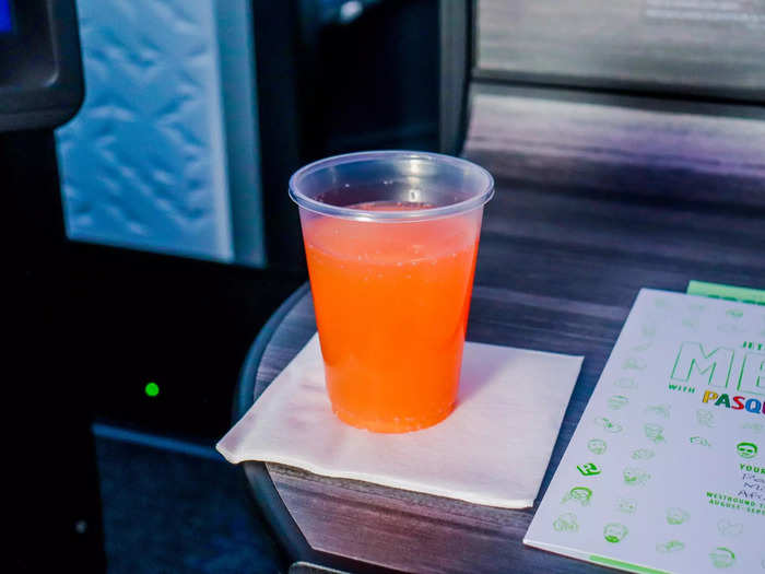 I settled into the seat and was offered a pre-departure beverage, with the recommendation being sparkling wine with blood orange juice. It was served in a plastic cup and quite refreshing.