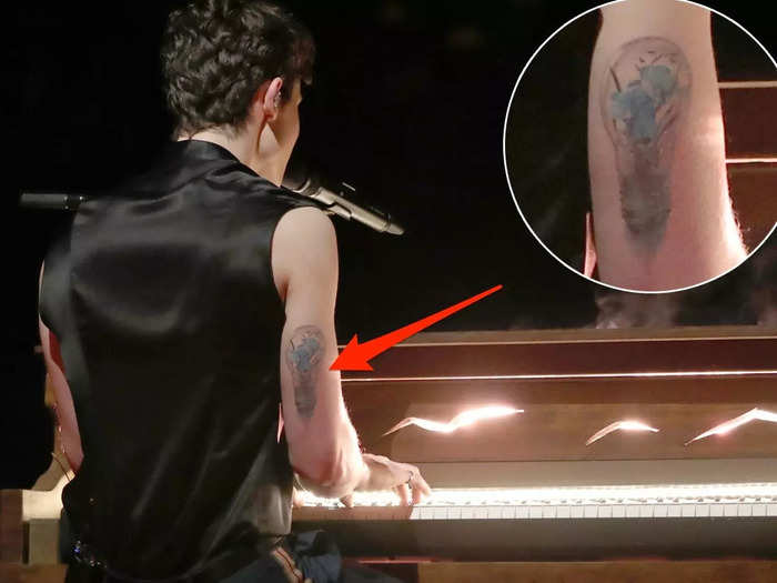 He got a light bulb on the back of his right arm commemorating his second studio album, "Illuminate."