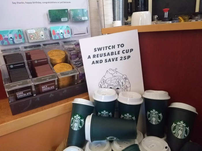 Next to the ordering station was a display of Starbucks merchandise you could buy, such as to-go cups ...