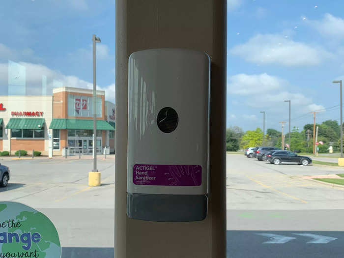 A hand sanitizer dispenser was mounted next to the seating area, near the other entrance.