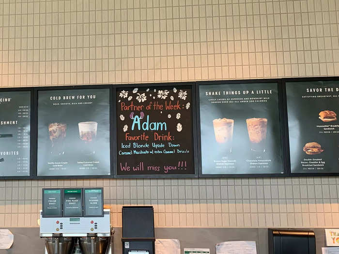 Signs on the menu board promoted drinks that were available, including cold brew and shaken espresso drinks.