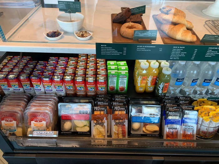 A refrigerated case beneath that display had juice boxes, water bottles, and various packaged snacks.