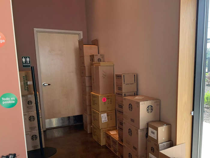 Off to the side of the side of the store, in front of the bathroom, more boxes were stacked along the wall.