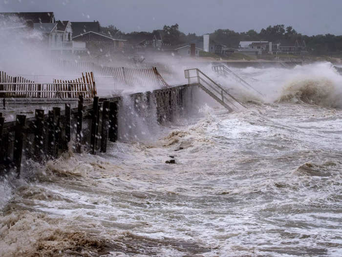 Strong waves crash against a seawall in Long Island