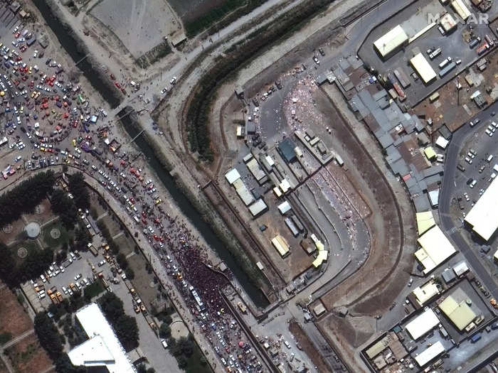 Satellite images showed large crowds of people in and around Hamid Karzai International Airport on Monday.