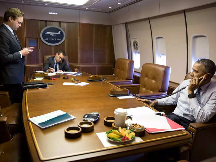 On the other side of the conference room, a decal that read "Air Force One" was displayed on wood paneling.