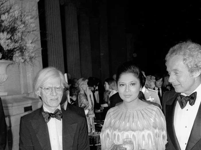 Andy Warhol was photographed wearing jeans and socializing with Imelda Marcos, a Filipina politician and convicted criminal, inside the 1976 event.