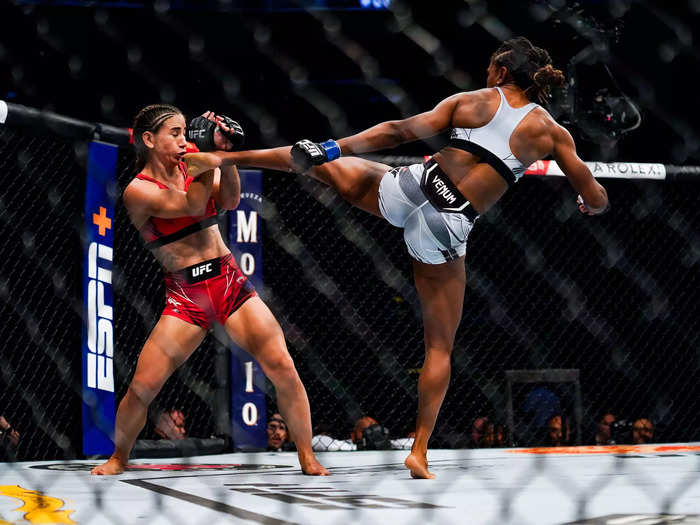 8/7: Angela Hill lands a kick on Tecia Torres during their Strawweight fight in Houston, Texas.