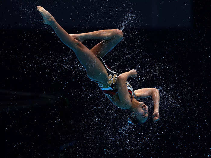 8/6: A member of Team Japan competes in the artistic swimming team technical routine at the Tokyo Olympics.