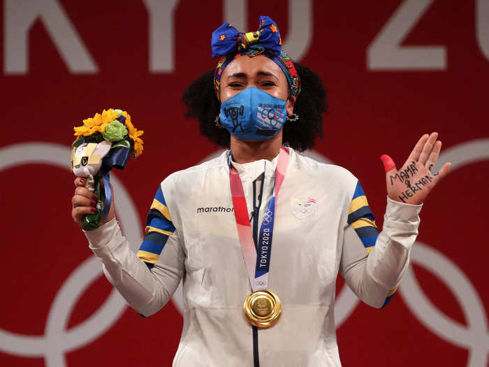 8/1: Gold medalist Neisi Patricia Dajomes Barrera of Team Ecuador poses with the gold medal during the medal ceremony for the Weightlifting - Women