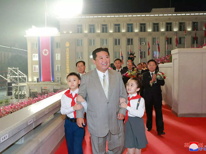 Kim was also looking noticeably slimmer compared to a few months ago, and was pictured walking on a red carpet with two children as officials applauded behind him.