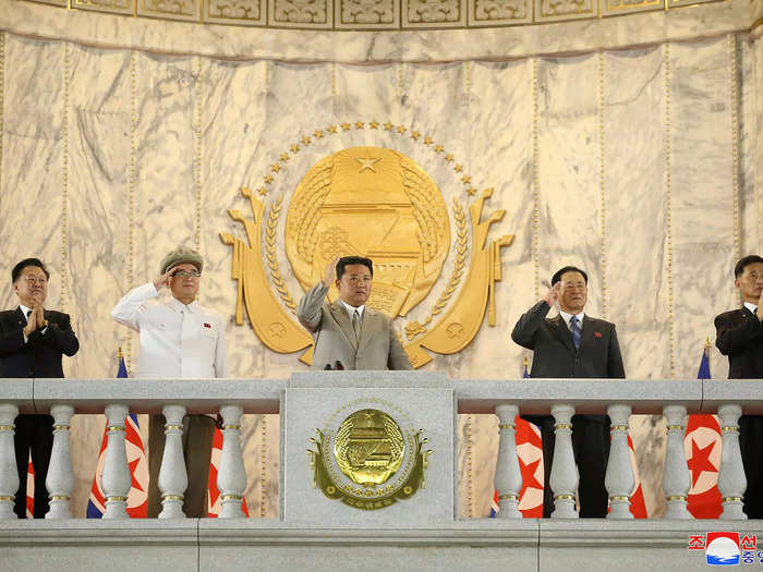 North Korean leader Kim Jong Un presided over the parade from a balcony. Photos show him wearing a tan Western-style suit, not the Mao suit he usually wears.