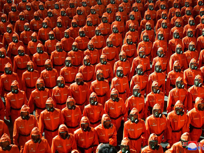 The military parade in Pyongyang featured a contingent of soldiers wearing orange hazmat suits - likely a display of the country