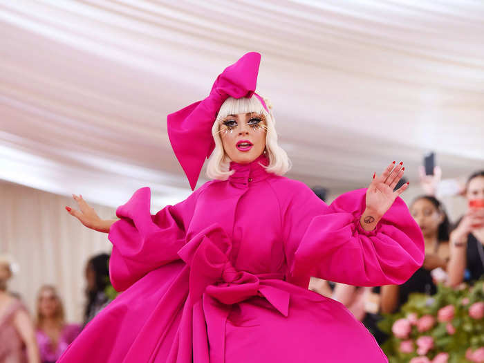 Lady Gaga showed up to the Met Gala wearing a massive, hot pink ball gown and matching headpiece.