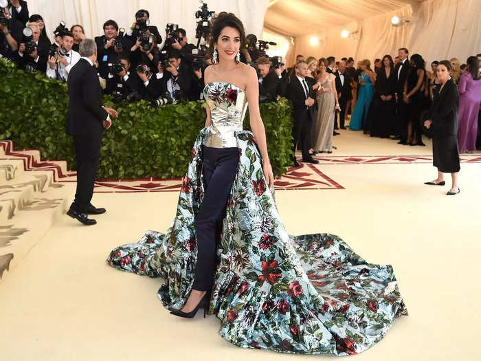 While co-chairing the 2018 Met Gala, Amal Clooney stunned in a pantsuit-gown hybrid by English designer Richard Quinn.