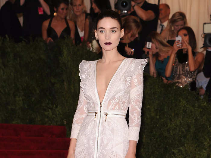 Co-chair Rooney Mara attended the Met Gala in 2013 wearing a low-cut, white lace gown by Givenchy.