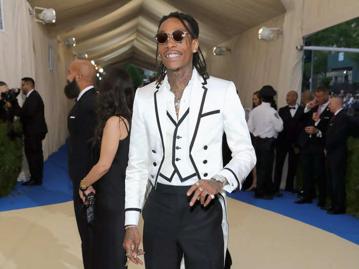 That year, Wiz Khalifa paired black pants with a structured white vest and blazer.