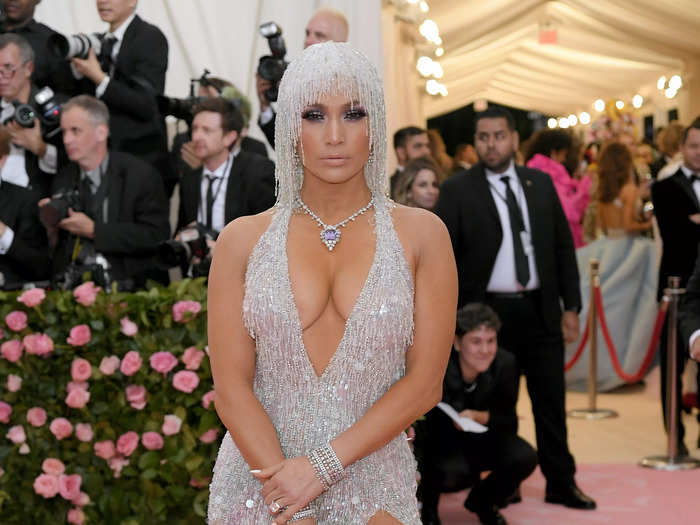 But Lopez went full glam for her most recent Met Gala appearance in 2019, opting for a plunging Versace dress that was dripping in jewels.