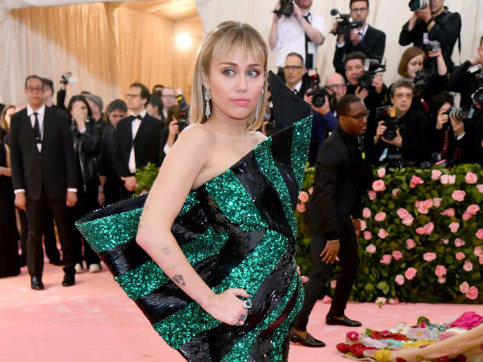 And Cyrus kept the punk vibes going with this sparkling green-and-black ensemble at the 2019 Met Gala.