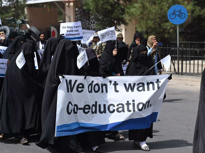 Women at the rally held signs in support of the Taliban