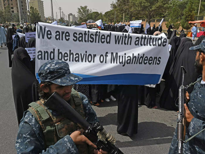 Afghan women held placards in support of the Taliban.