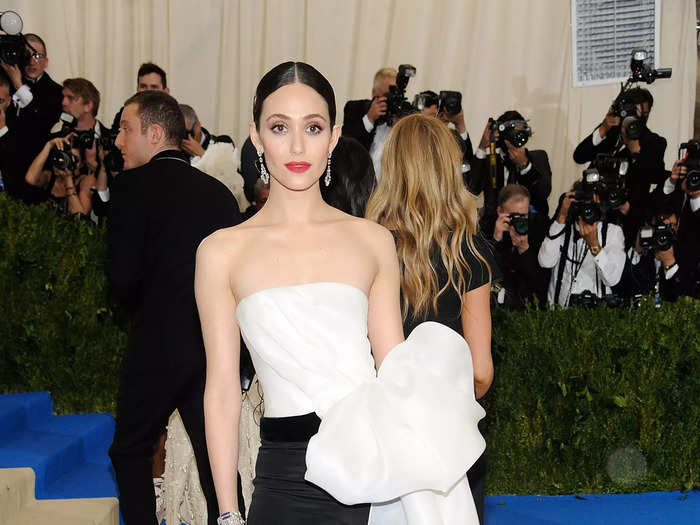 Emmy Rossum looked chic at the 2017 Met Gala in a Carolina Herrera jumpsuit with a giant bow on her hip.