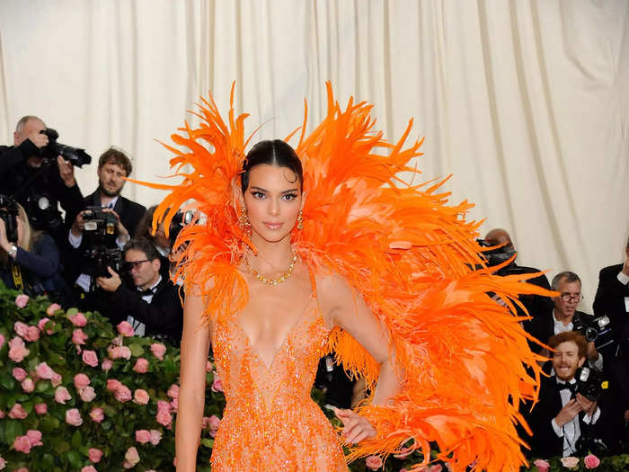 Kendall Jenner looked like a Vegas showgirl in a bright-orange feathered dress at the 2019 Met Gala.