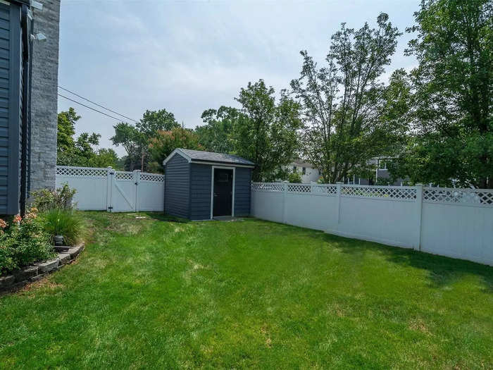 Outside, there is a modest-sized backyard, which is fenced in.