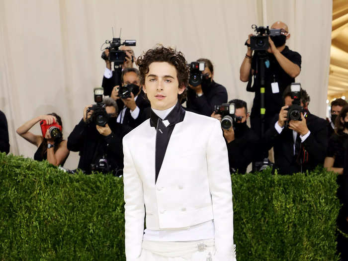 Timothée Chalamet accented his all-white suit with a black collar and worn-in Converse.