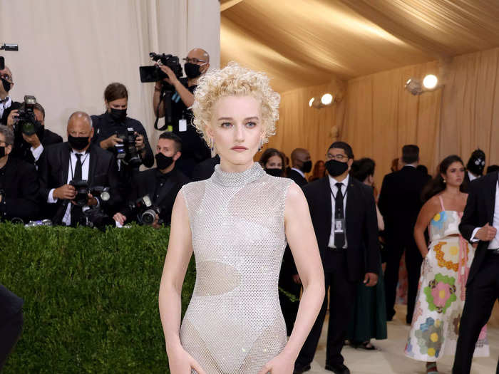 Julia Garner arrived in a beautiful Stella McCartney look that was made from a lightweight fishnet and was covered in Swarovski crystals.