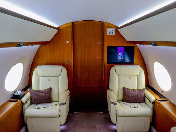 Two pairs of club seats comprise the first living area for a total of four seats, each with its own window.