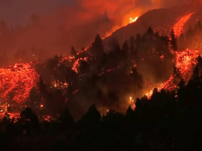 The eruption has sent lava edging through surrounding forests.