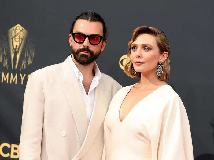 Robbie Arnett and Elizabeth Olsen looked dashing in coordinated cream looks.