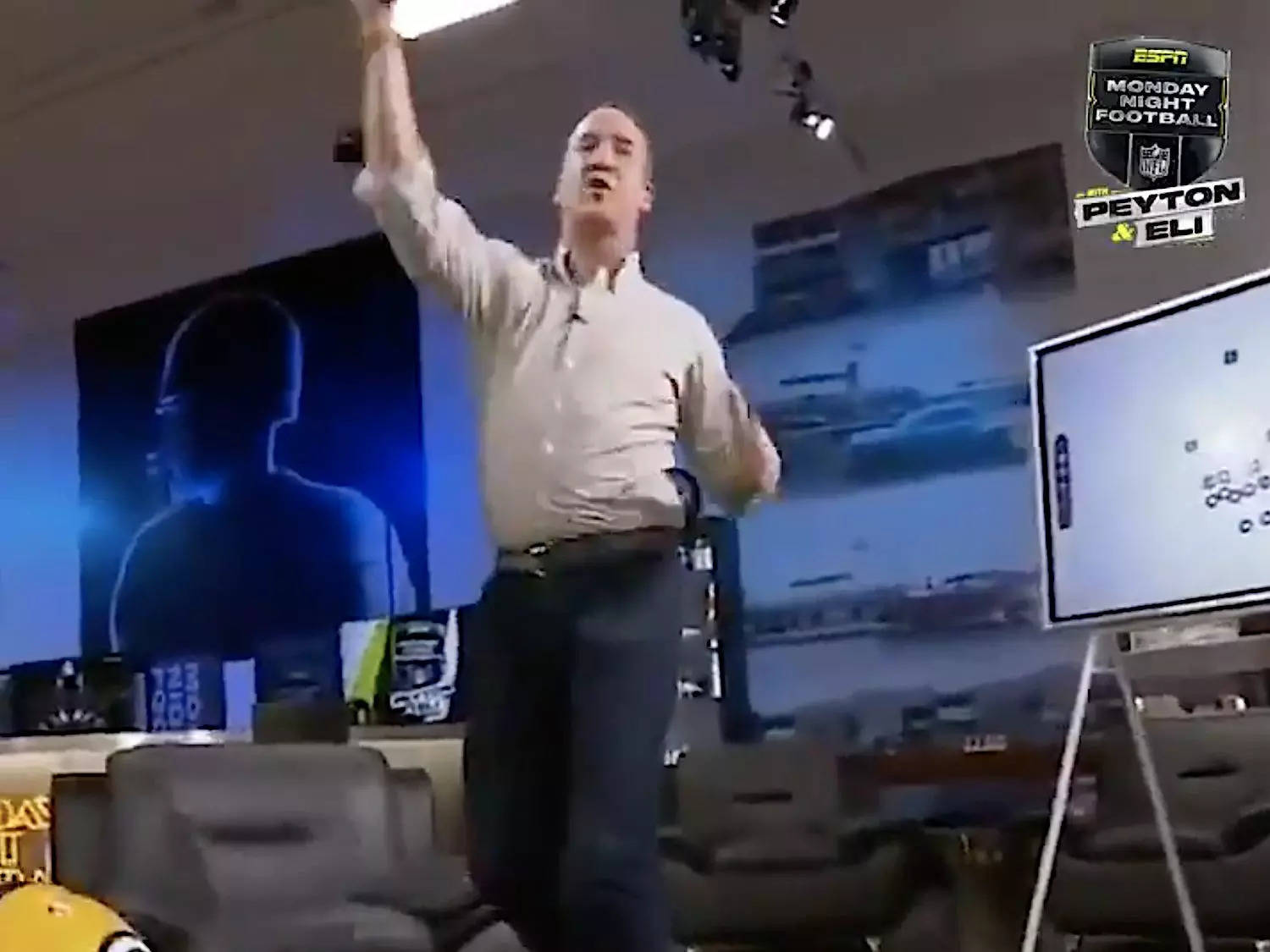 Screenshot shows Peyton Manning imitating an Aaron Rodgers throw.