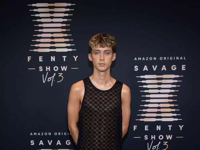 Troye Sivan looked comfortable in a sheer top and silver shorts.