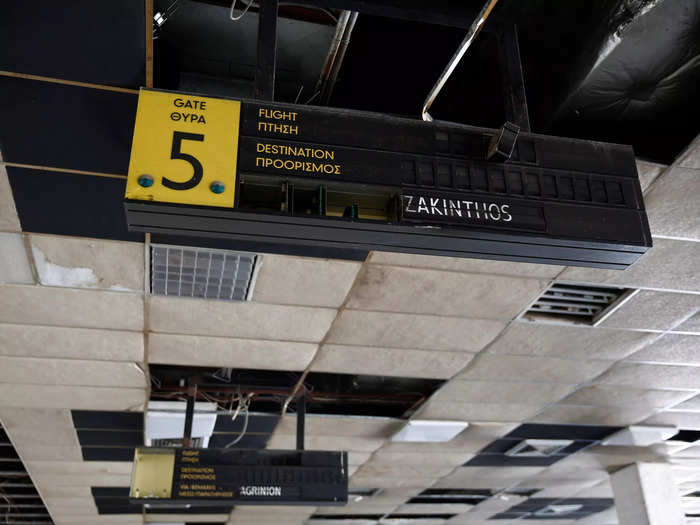 An announcement board still hangs inside a deserted hall at the west terminal of the former Athens International airport in Greece.