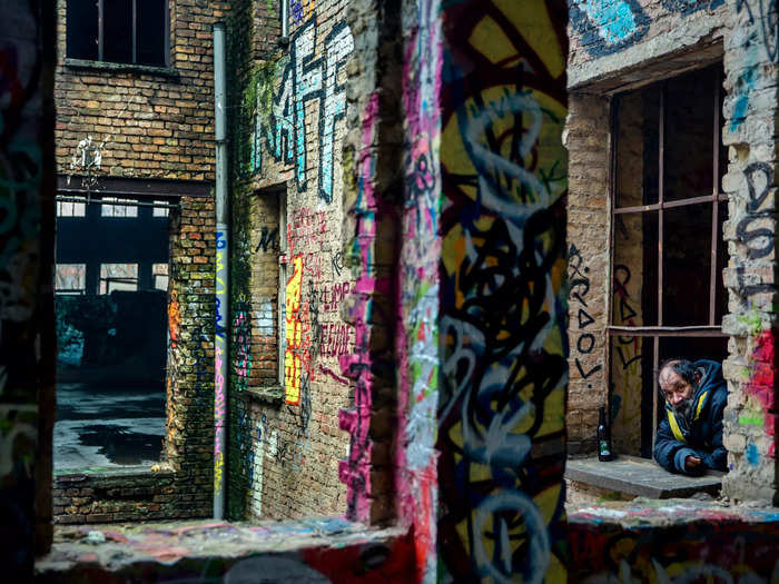 A man looks out of the window of Eisfabrik, a former ice factory, in Berlin, Germany.