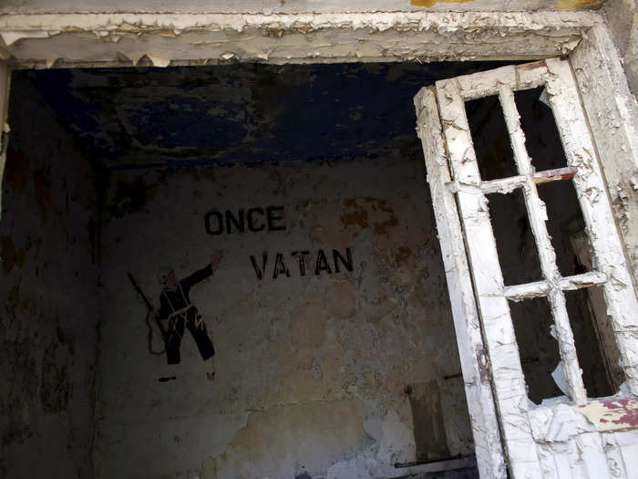 A military sign that reads "Homeland first" is pictured at an abandoned building on the deserted Yassiada island in the Marmara Sea off Istanbul, Turkey.