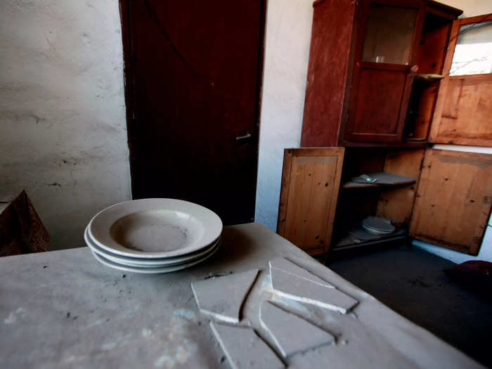 Plates still sit on the table of an abandoned house in the village of Kleitos, Greece.