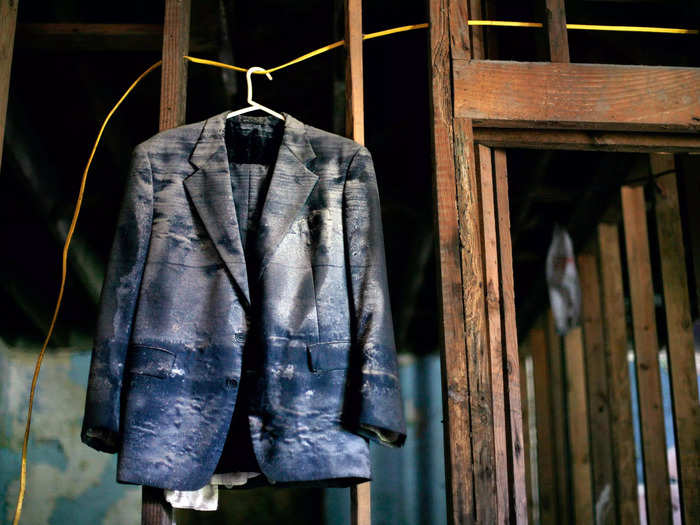 A suit hangs inside a house in the Ninth Ward area of New Orleans, Louisiana, in an area damaged by Hurricane Katrina.