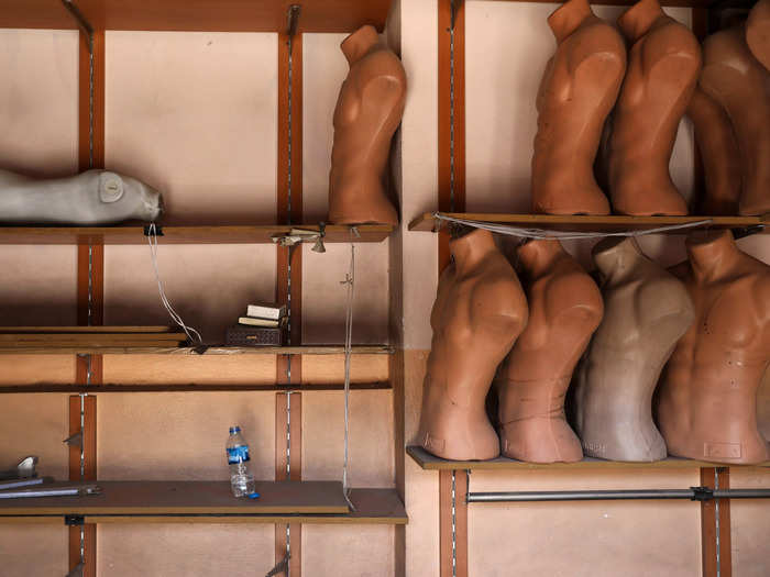 Mannequins lie on shelves in an abandoned shop in western Mosul, Iraq.