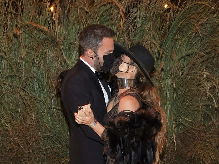 Affleck and Lopez kissed through their masks as paparazzi snapped photos.