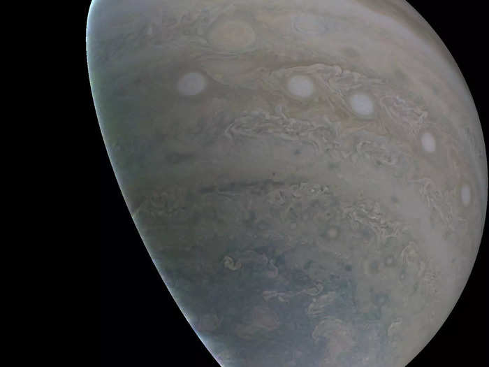 Juno beams the raw data to Earth as black-and-white photo layers that represent red, blue, and green.